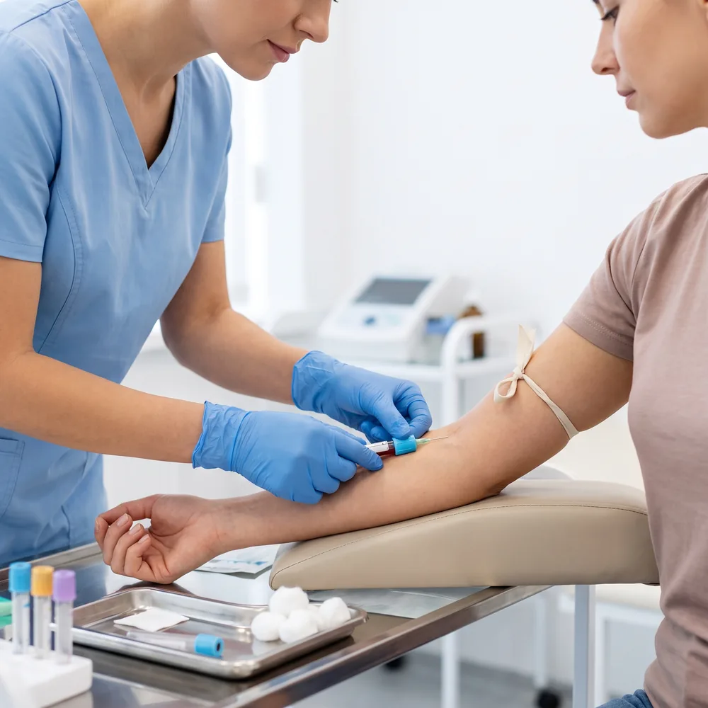 A nurse taking a blood sample from a woman